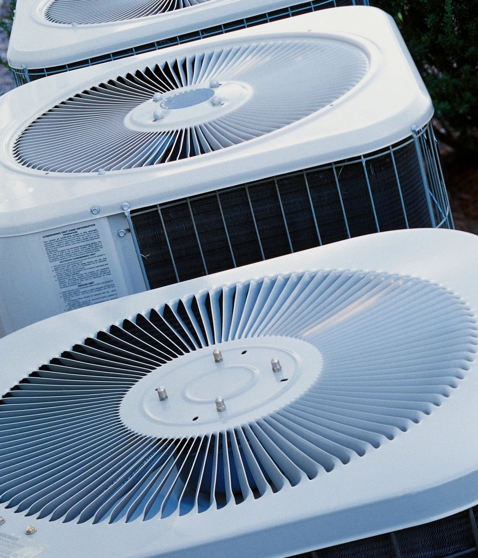 A close up of two air conditioners on top of each other.